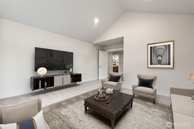 carpeted living room with high vaulted ceiling and baseboards