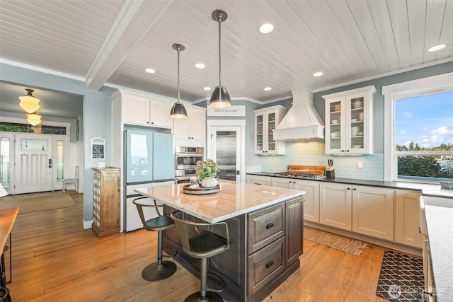 1831 Miracle Mile Dr E, Port Orchard, WA 98366 - kitchen featuring appliances with stainless steel finishes, pendant lighting, white cabinetry, and custom exhaust hood