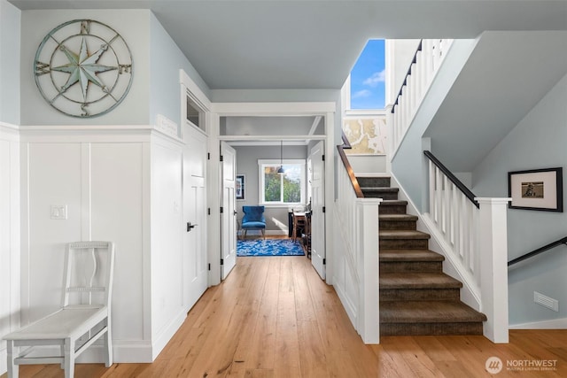 1831 Miracle Mile Dr E, Port Orchard, WA 98366 - stairway with a decorative wall, wood finished floors, and wainscoting