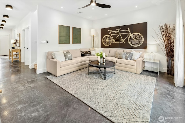 living area featuring finished concrete flooring, baseboards, a ceiling fan, and recessed lighting