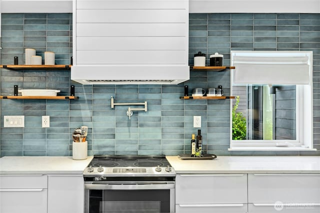 kitchen with electric stove, open shelves, tasteful backsplash, white cabinetry, and light stone countertops