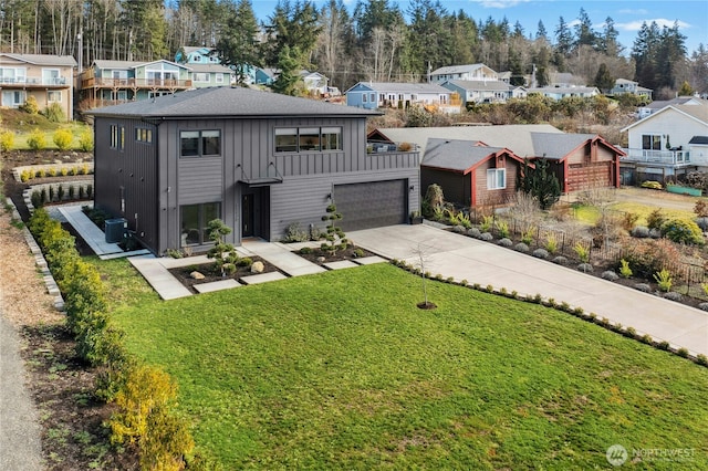 view of front of home with concrete driveway, board and batten siding, and a residential view