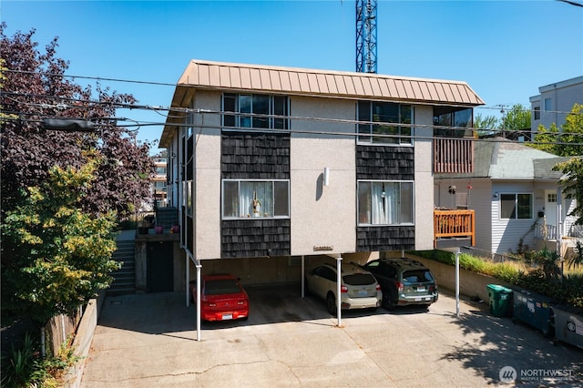 view of building exterior featuring covered parking