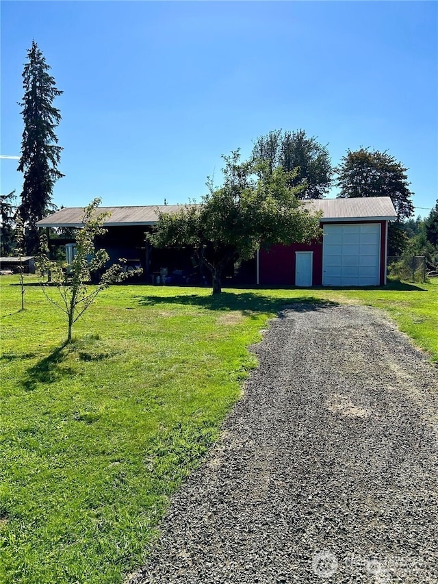 4421 89th Ave SE, Olympia, WA 98501 - view of front of property with a detached garage, a front yard, and driveway