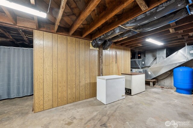4421 89th Ave SE, Olympia, WA 98501 - unfinished below grade area featuring wood walls and fridge