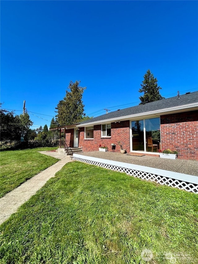 4421 89th Ave SE, Olympia, WA 98501 - rear view of property featuring a yard and brick siding