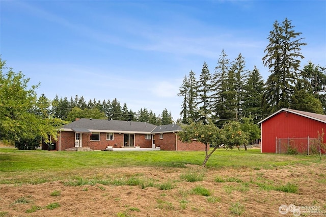4421 89th Ave SE, Olympia, WA 98501 - back of house featuring a lawn, a patio area, and brick siding