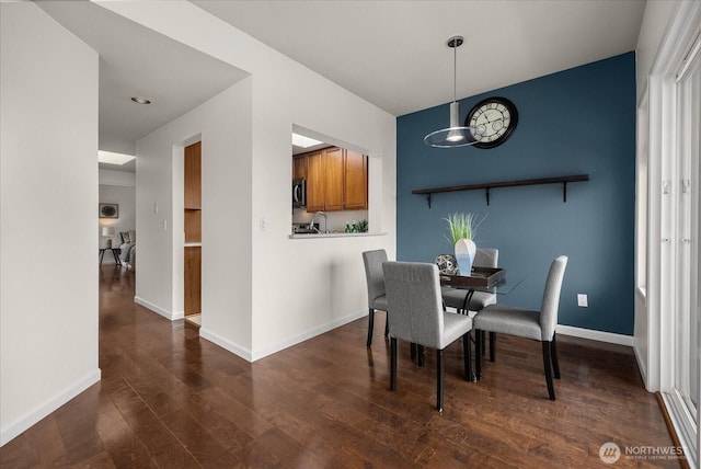 dining room with dark wood finished floors and baseboards