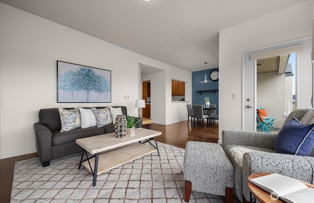 living room featuring baseboards and wood finished floors