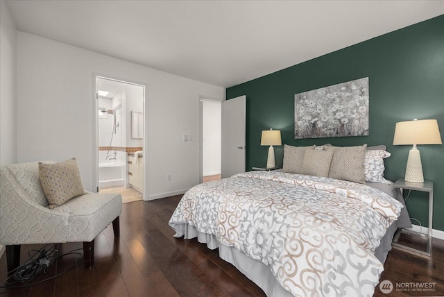 bedroom with baseboards, dark wood-style flooring, and ensuite bathroom