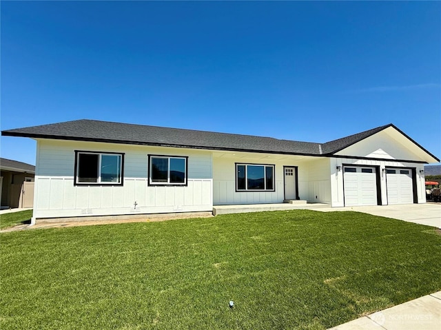 2575 1st St SE, East Wenatchee, WA 98802 - ranch-style home featuring a garage, driveway, a front lawn, board and batten siding, and roof with shingles