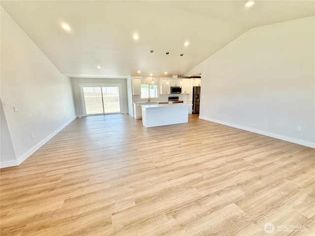 2575 1st St SE, East Wenatchee, WA 98802 - unfurnished living room with light wood finished floors, recessed lighting, and lofted ceiling