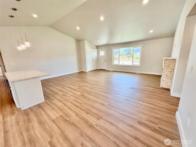 2575 1st St SE, East Wenatchee, WA 98802 - unfurnished living room with lofted ceiling, light wood-style flooring, and recessed lighting