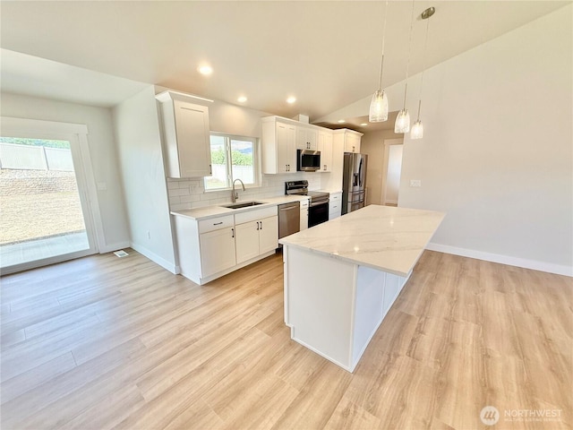 2575 1st St SE, East Wenatchee, WA 98802 - kitchen with appliances with stainless steel finishes, backsplash, a center island, white cabinetry, and recessed lighting