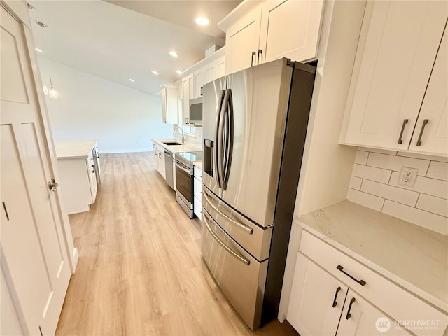 2575 1st St SE, East Wenatchee, WA 98802 - kitchen featuring appliances with stainless steel finishes, decorative backsplash, light wood-type flooring, light countertops, and recessed lighting
