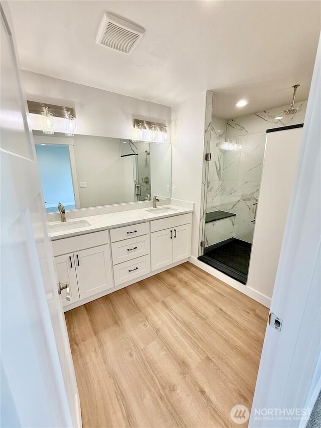 2575 1st St SE, East Wenatchee, WA 98802 - full bathroom featuring a marble finish shower, double vanity, and wood finished floors