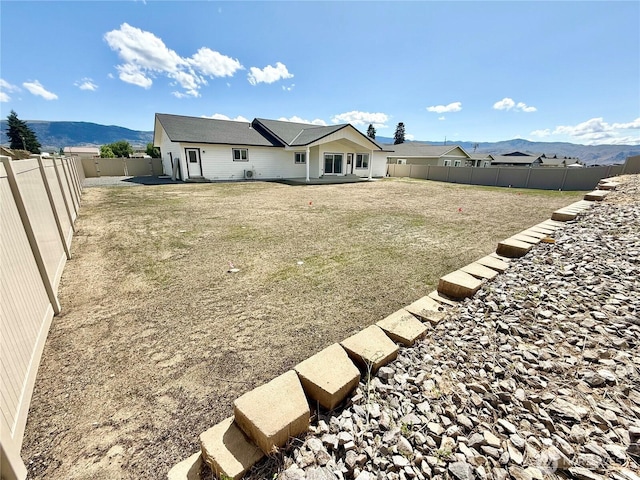 2575 1st St SE, East Wenatchee, WA 98802 - rear view of property featuring a mountain view and a fenced backyard