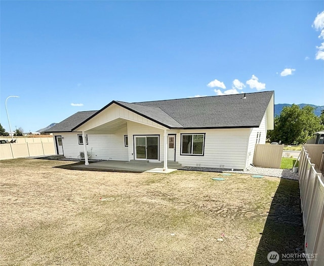 2575 1st St SE, East Wenatchee, WA 98802 - back of house featuring a fenced backyard, a patio area, and roof with shingles
