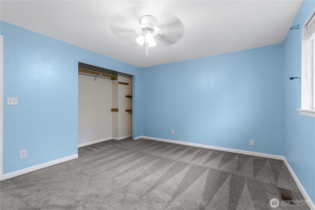 unfurnished bedroom with a closet, visible vents, carpet, and baseboards