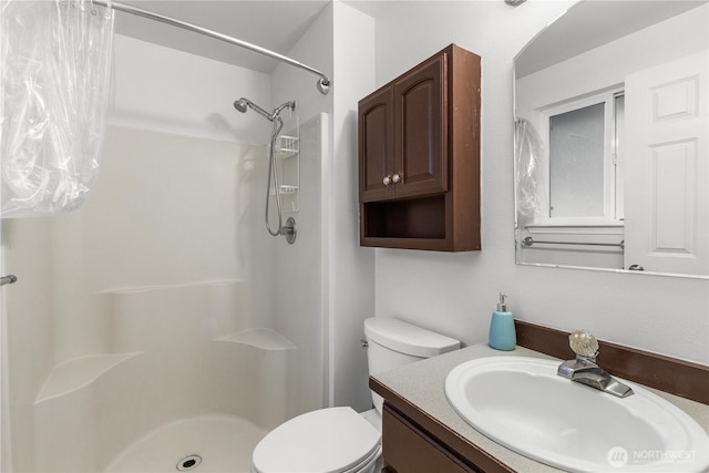 full bath featuring vanity, toilet, and a shower stall