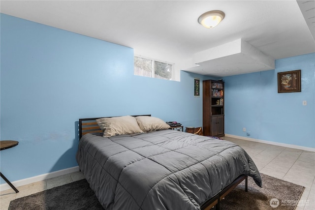 bedroom featuring baseboards and tile patterned flooring