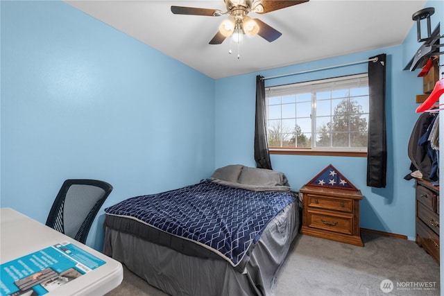 carpeted bedroom with baseboards and a ceiling fan