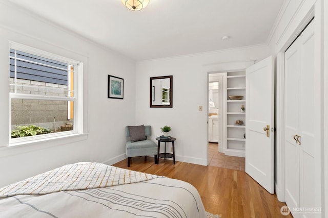 3657 23rd Ave W, Seattle, WA 98199 - bedroom with light wood-style flooring, ornamental molding, and a closet