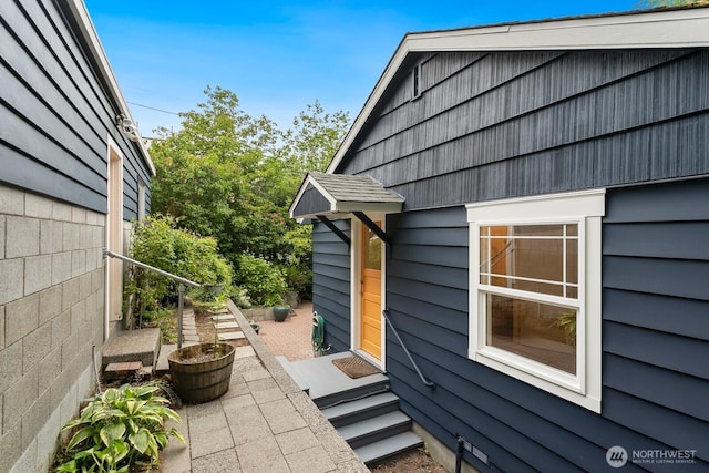 3657 23rd Ave W, Seattle, WA 98199 - view of side of home featuring entry steps and a patio