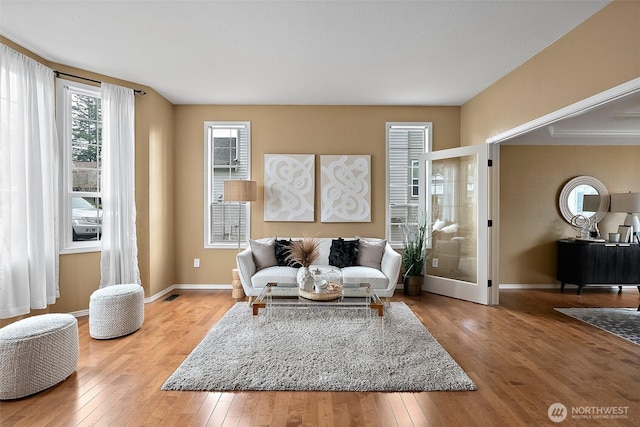 living area with hardwood / wood-style flooring and baseboards