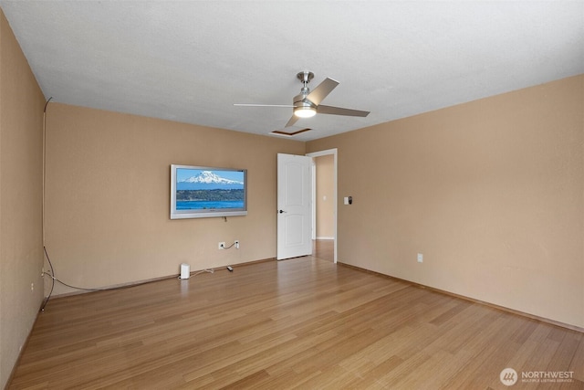 unfurnished room with light wood-type flooring, ceiling fan, and visible vents