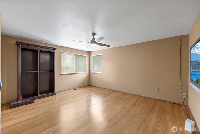 unfurnished bedroom featuring light wood-style flooring and a ceiling fan