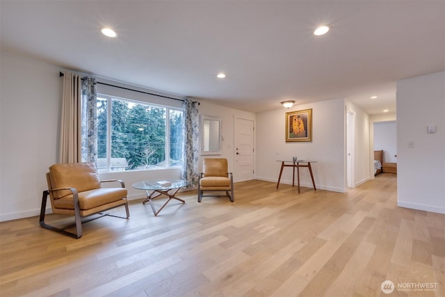 sitting room with light wood-style floors, baseboards, and recessed lighting