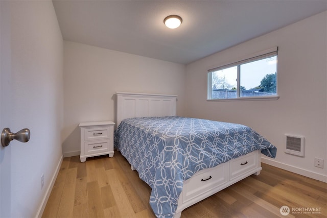 bedroom with light wood-type flooring and baseboards