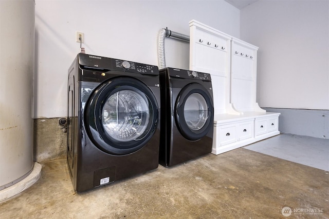 laundry room featuring laundry area, water heater, and independent washer and dryer