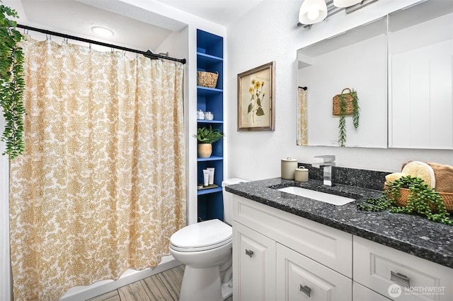 bathroom with a shower with curtain, vanity, and toilet