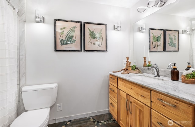 full bathroom with wood finished floors, vanity, toilet, and baseboards