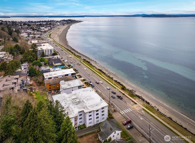 drone / aerial view featuring a water view and a beach view