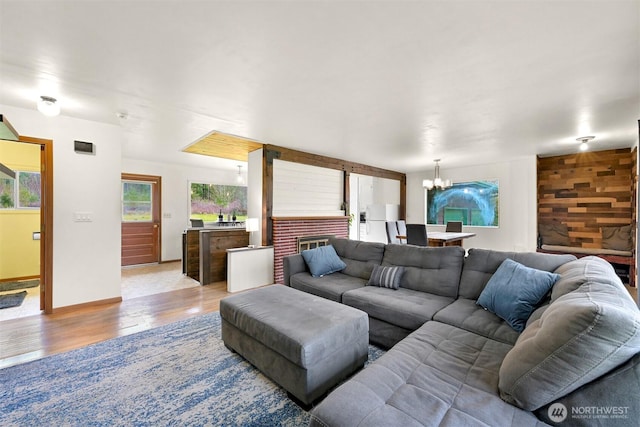 living room featuring a notable chandelier and wood finished floors