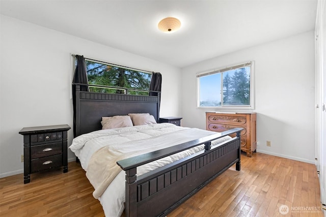 bedroom featuring light wood-style flooring and baseboards