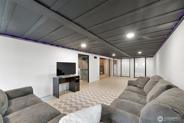 living area featuring light wood-type flooring and recessed lighting