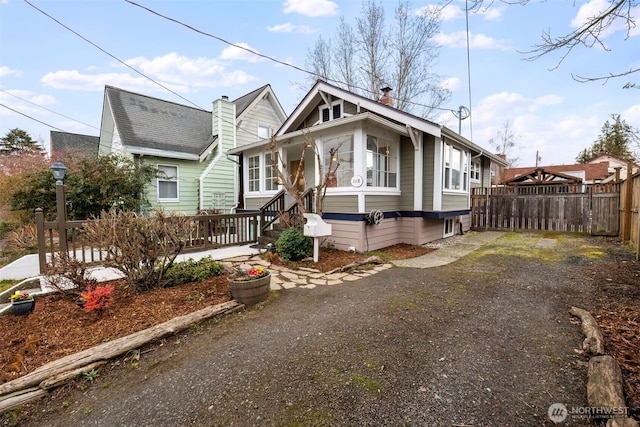 view of front of home featuring fence