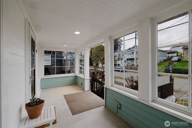 sunroom / solarium featuring a residential view