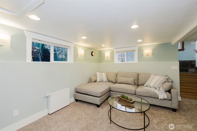 carpeted living area with baseboards, stairway, recessed lighting, and radiator