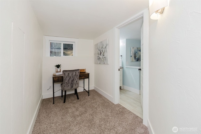 carpeted office featuring baseboards