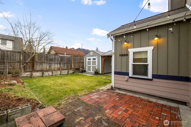 view of yard featuring a patio area, a shed, an outdoor structure, and a fenced backyard