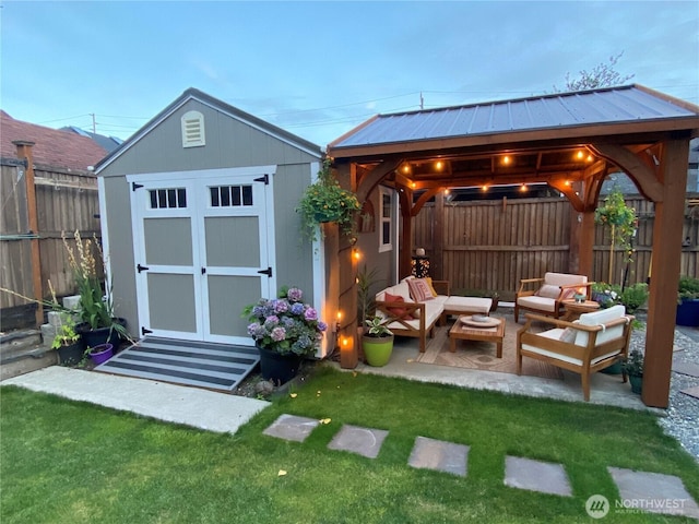 view of shed with a fenced backyard, outdoor lounge area, and a gazebo