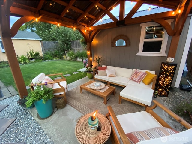 view of patio / terrace featuring fence, an outdoor living space, and a gazebo