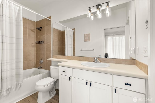 bathroom with toilet, shower / bathtub combination with curtain, wood finished floors, and vanity