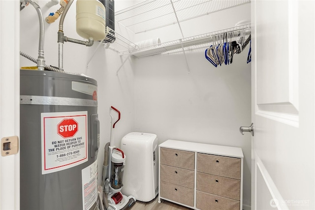 utility room with electric water heater