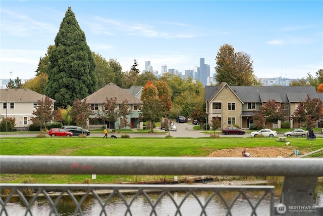 view of home's community with a view of city and a water view